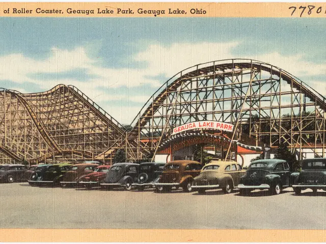 This is a photograph on a paper. In the image we can see cars on the road and in the background...