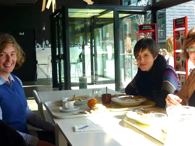 In this picture there are group of people, they are sitting around the table to the right and left...