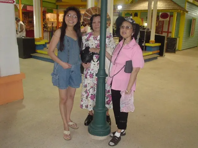 In this image we can see three ladies standing. Two ladies are wearing specs. And two are wearing...