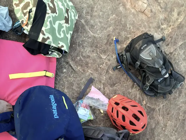 In this Image I see number of bags and a helmet on the ground.