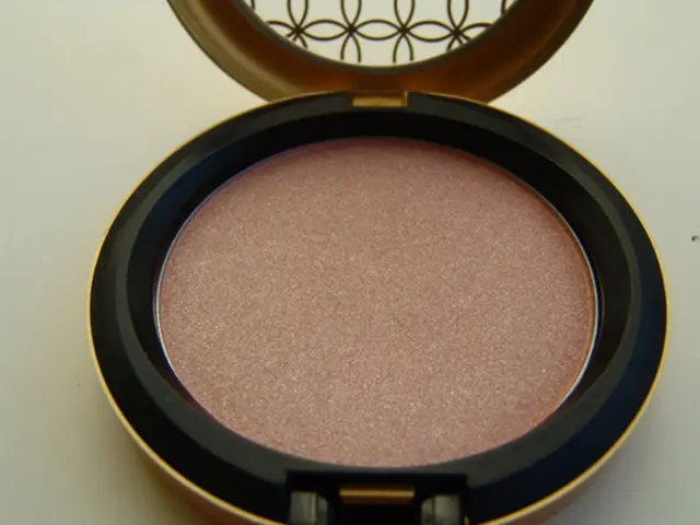 In this picture we can see a Rose gold colored powder in a compact.