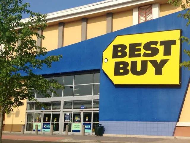 In this image I can see a building where best buy is written on it. I can also see number of trees...