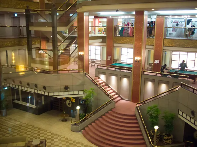 In this image there are buildings. Left side there are staircases. Bottom of the image there are...