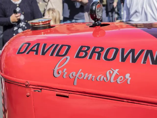 In this image I can see red color fuel tank and something is written on it. In the background I can...