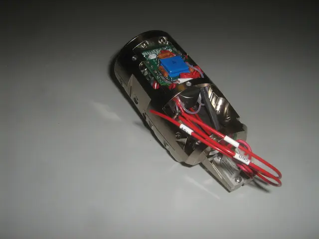 In this picture we can see a device with red color wires and this is placed on a platform.