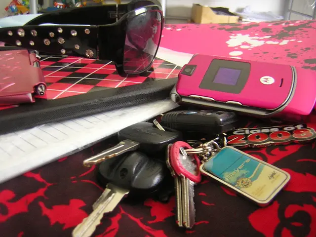 This picture shows keys, mobile and sunglasses and a paper on the table and we see a carton box and...