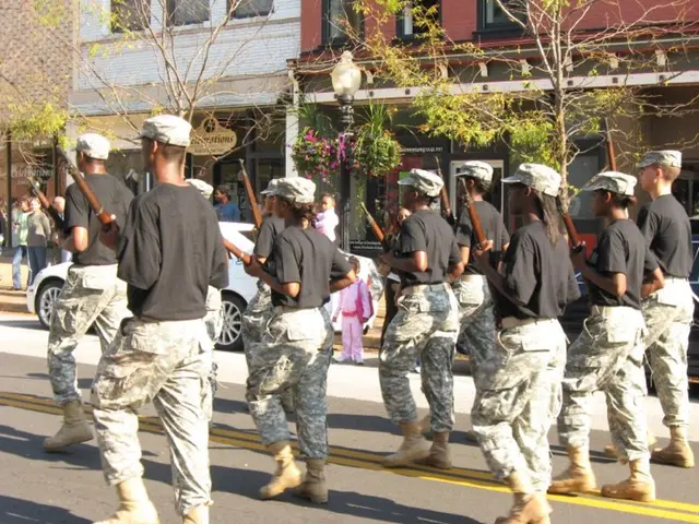 In this image few people wearing black top are holding the guns. They are wearing caps. They are...